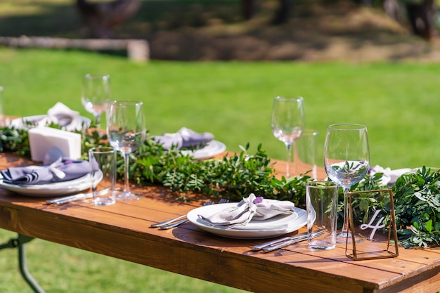 Preparing for an open-air party. Decorated with fresh flowers served tables. Table number. Decoration Details.