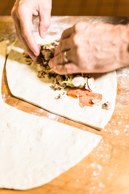 Preparing Pepperoni calzone in Italian restaurant.