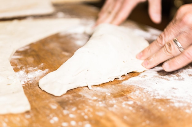 Preparing Pepperoni calzone in Italian restaurant.