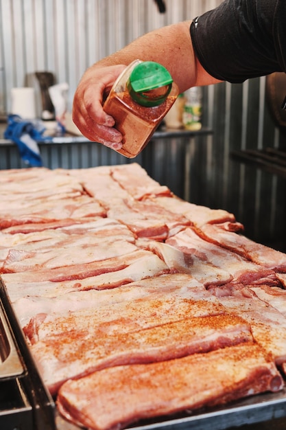 Photo preparing raw pork ribs for grilling