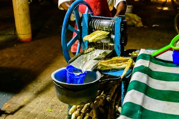 Preparing sugarcane juice at the Forodhani gardens in Stone town at night Zanzibar Tanzania