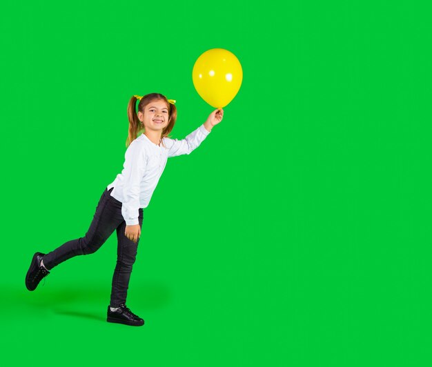 Photo preschool girl playing with illuminating balloon on