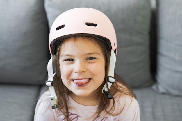 Preschool girl portrait with safety for outdoors activities Pink helmet and wrist pads