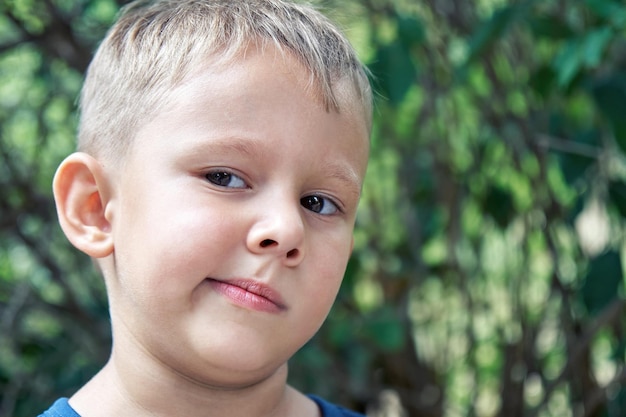 Preschooler boy grimaces making weird face expressions