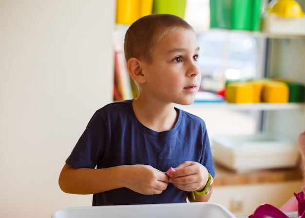 The preschooler looks for the necessary toy detail