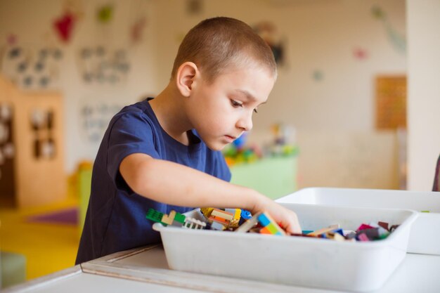 Photo the preschooler looks for the necessary toy detail