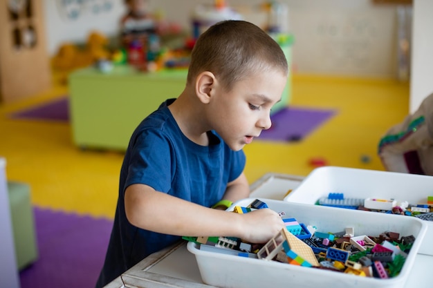 Photo the preschooler looks for the necessary toy detail