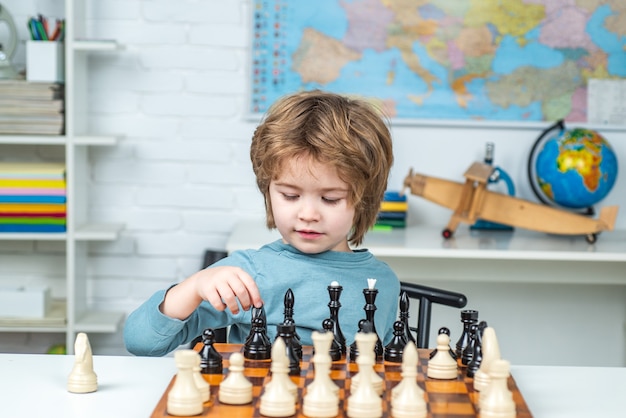 Preschooler or schoolboy thinking child chess strategy kid playing chess