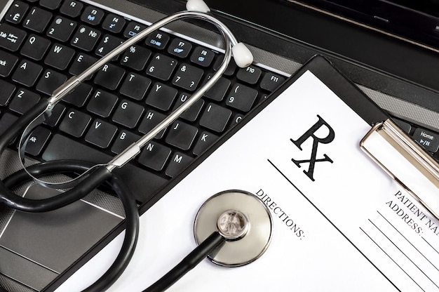 Prescription form with stethoscope on the laptop keyboard