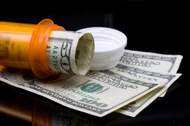 Prescription pill bottle with money