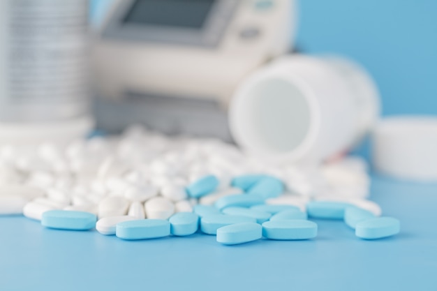 Prescription pills, scattered. Blue toned image, with shallow depth of field. of copy space.