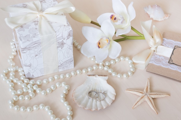 Present, beads, seashells, orchid and rings