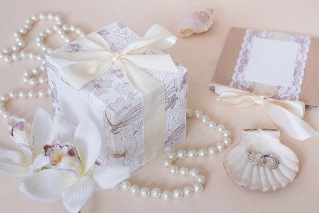 Present, beads, seashells, orchid and rings