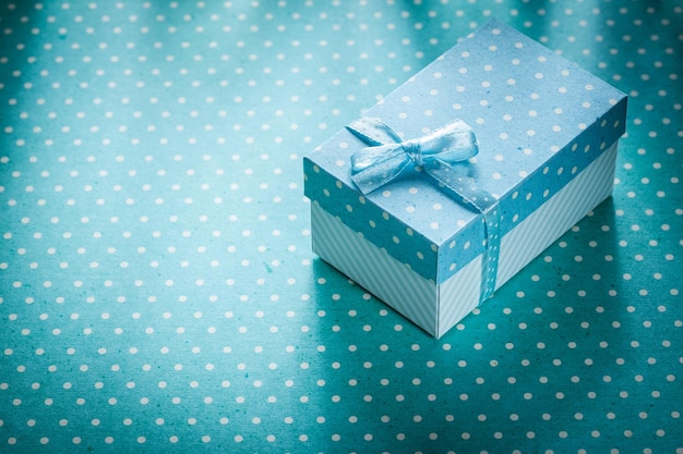 Photo present box on blue polkadot background holidays concept