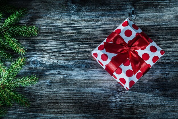 Present box fir tree branch on wooden board