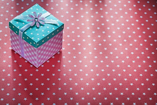 Present box on red fabric holidays concept