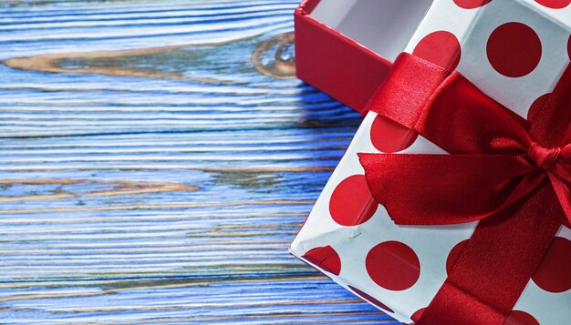 Present box on vintage wooden background