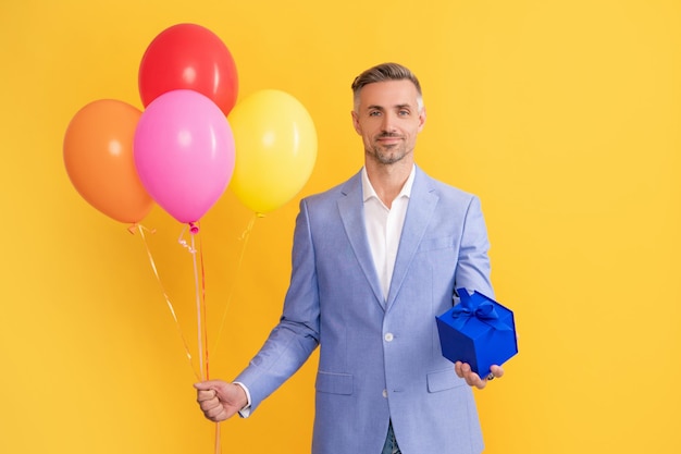 Present and gifts buy shopping guy with purchase on yellow background business reward