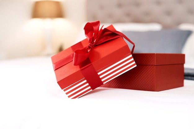 Photo present love gift and bedroom with no people with celebration box for valentines day red gifts presents and bed in a house with surprise celebrating and birthday package with ribbon and zoom