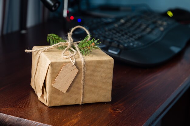 Presente in involucro rustico sul posto di lavoro. concetto di celebrazione dell'ufficio