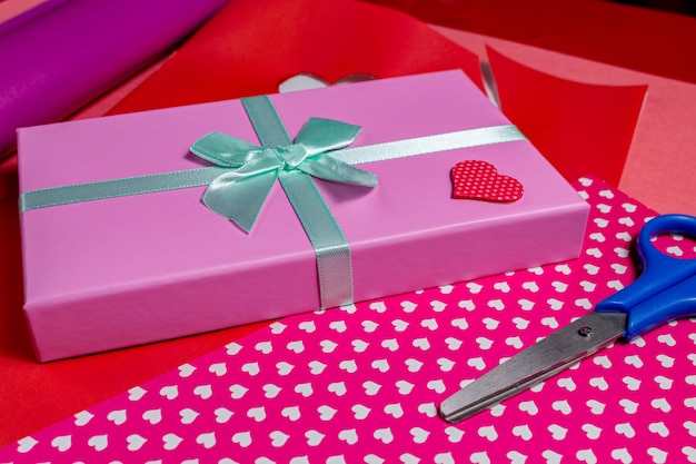 Present for Valentine day with heart and scissors. Gift wrapping