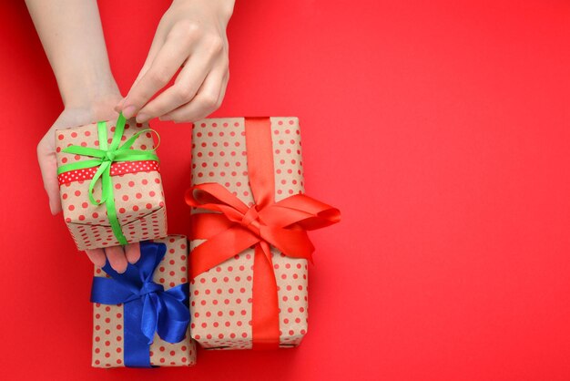 Present in woman hand on red background.