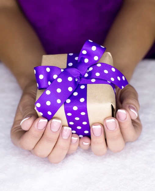 Present in a women hand's with french manicure