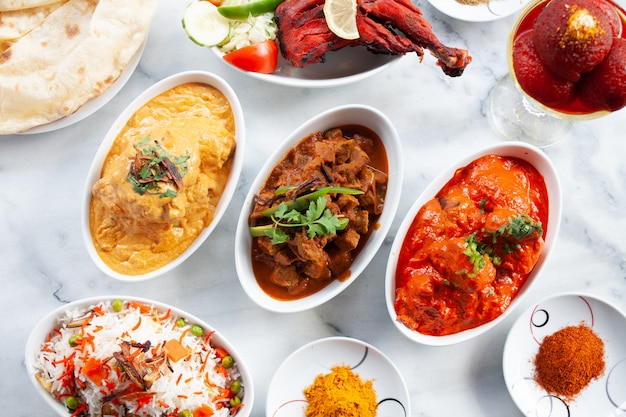 Photo presentation of traditional indian food dishes on marble table