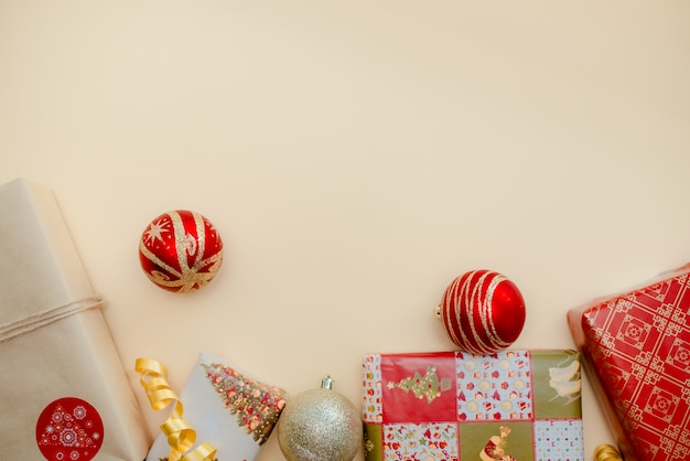 Presents and christmas balls lying on each other