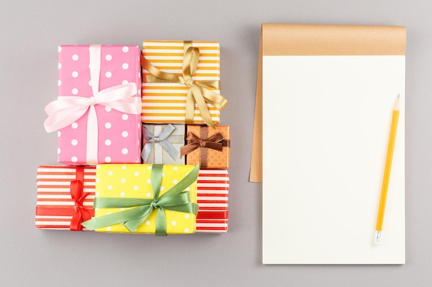 Presents in colored paper with an open notebook