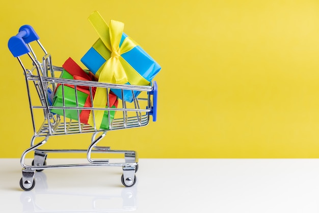 Presents in shopping cart. Closeup