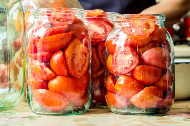 Preservation, pickling vegetables of tomatoes and cucumbers. Selective focus.