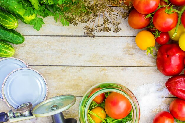 Preservation, pickling vegetables of tomatoes and cucumbers. Selective focus.