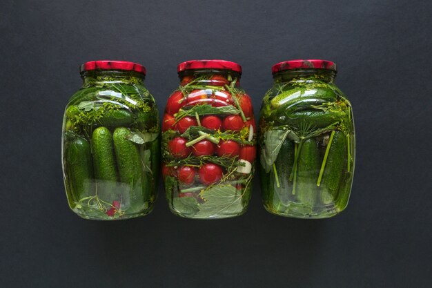 Preservation of tomatoes and cucumbers. Jars of pickles and tomatoes for the winter.