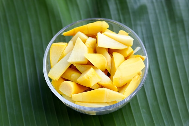 Preserved bamboo shoot in glass bowl on banana leaf