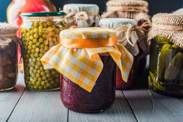 Preserved vegetables on wooden background