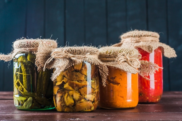 Preserved vegetables on wooden background