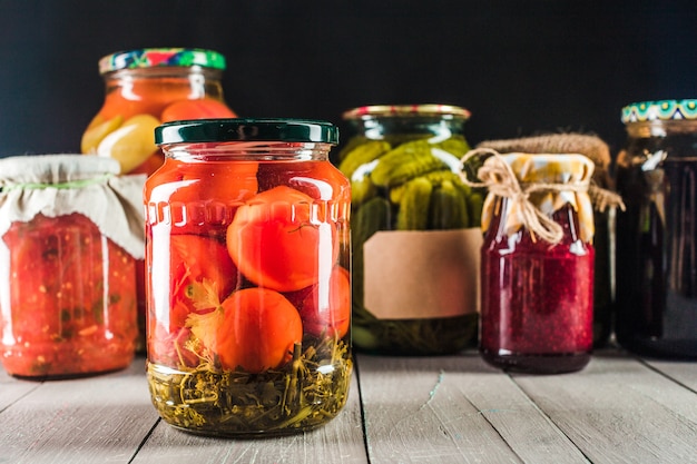 Preserved vegetables on wooden background