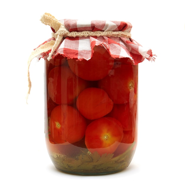 Preserves. Pickled tomato in glass isolated on white background