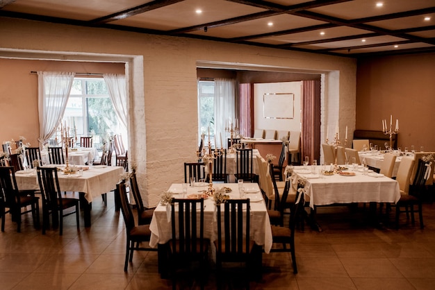 the presidium of the newlyweds in the banquet hall of the restaurant is decorated with candles