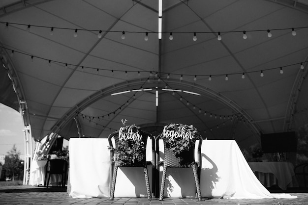 the presidium of the newlyweds in the banquet hall of the restaurant is decorated