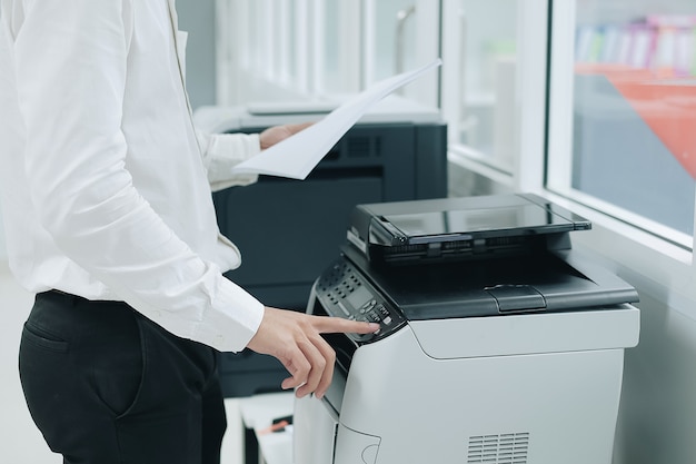 press button on panel of printer scanner or laser copy machine in office