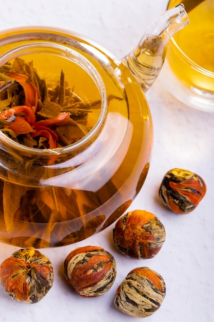 Pressed Green Chinese Oolong Tea Balls blooms in a teapot in the form of a flower