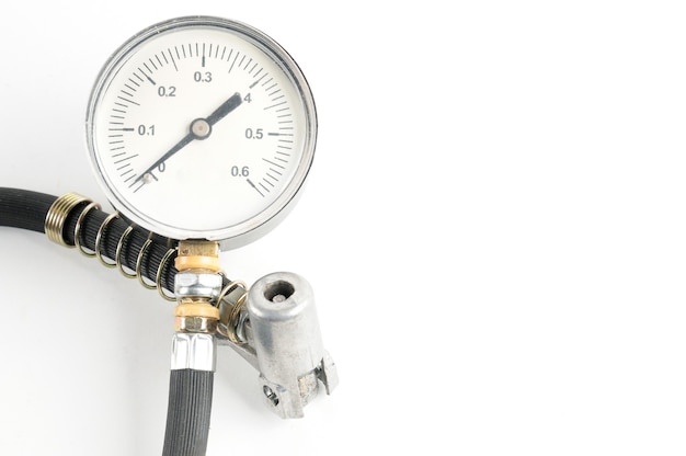 Pressure gauge for measuring air pressure in automobile tires close-up on an isolated white