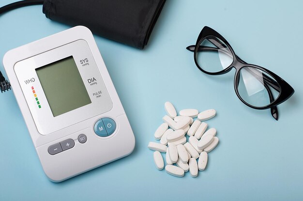 Photo pressure measuring device tonometer and a row of white pills eyeglasses