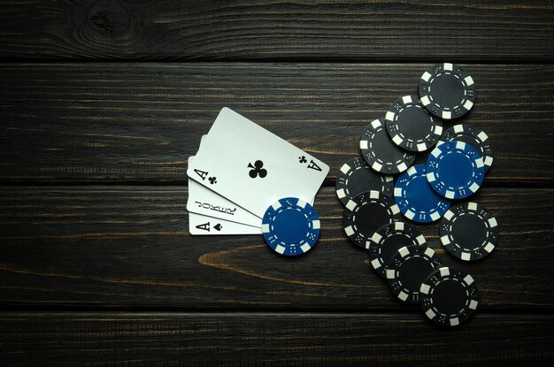 写真 ポーカークラブの黒いテーブルにチップ付きのカード 広告用の無料スペース