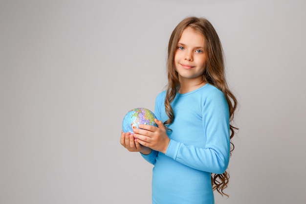 Preteen girl holding an Earth globe