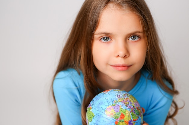 Preteen girl holding an Earth globe