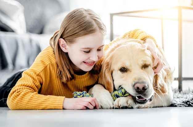 Preteen girl with golden retriever dog