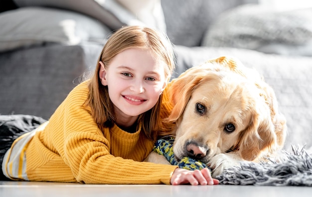 Preteen girl with golden retriever dog